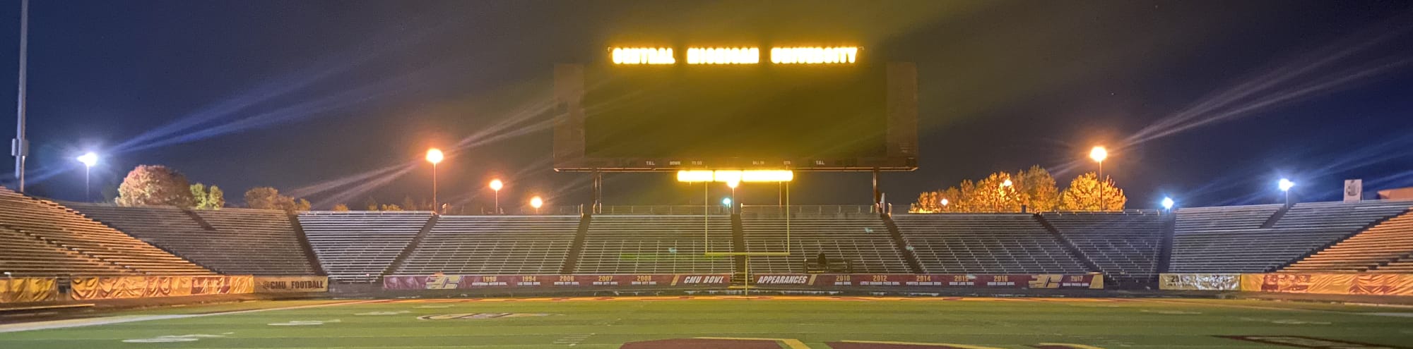 empty football stadium at night under the lights Raleigh