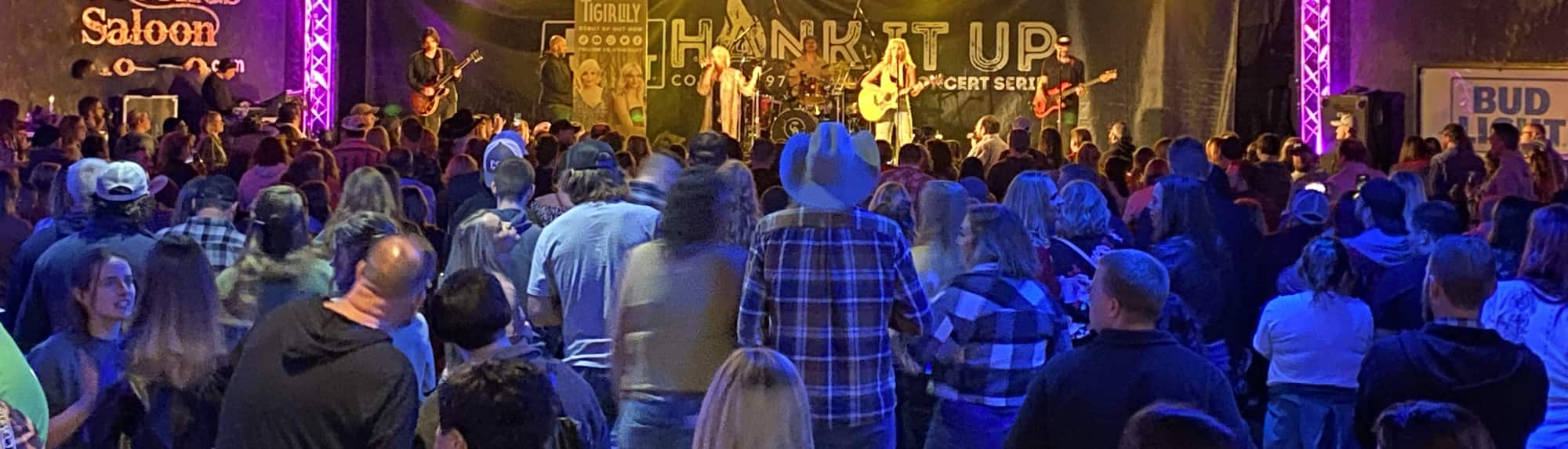country concert with fans wearing cowboy hats Raleigh
